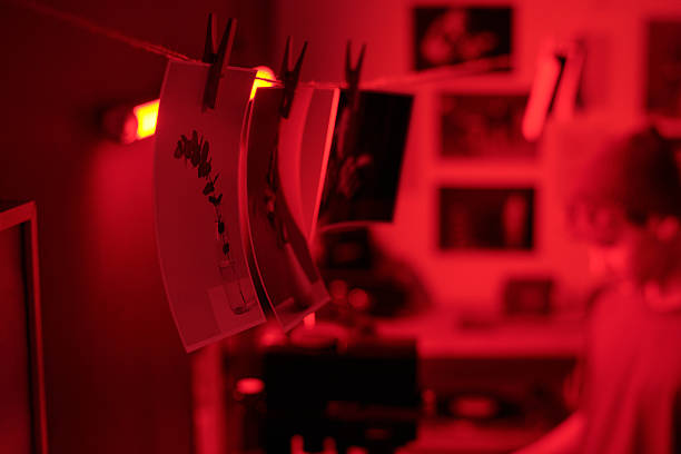 istock Close Up of Photo Prints Hanging On String Drying in Darkroom 2203032732