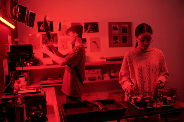 istock Two Photographers Working On Developing Photo Prints in Darkroom 2203032741