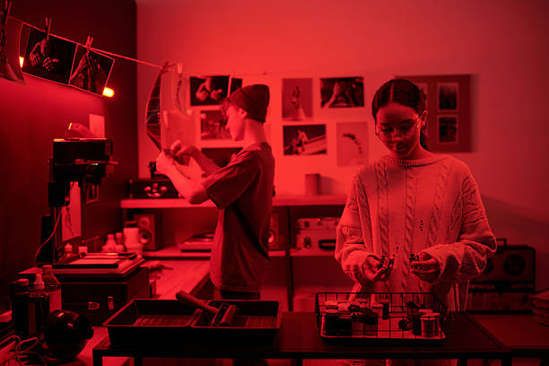 istock Two Photographers Working in Darkroom 2203032743