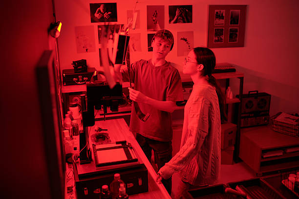 istock Teen Boy Doing Selections in Darkroom 2203032753