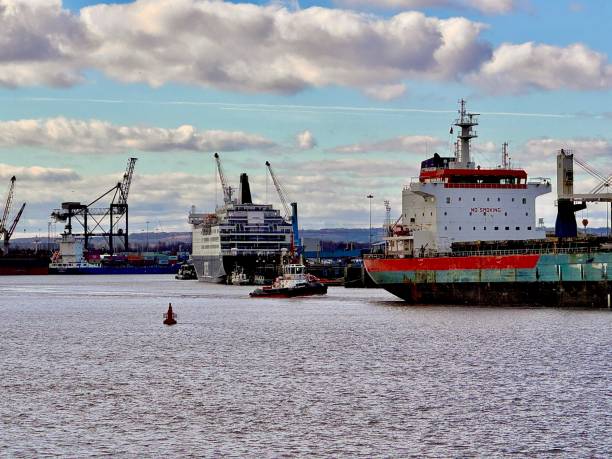 A big container ship loaded with colourful containers just outside the Port of Aarhus on a cloudy day in Denmark.The vessel CAPE FERROL is a Container Ship built in 2008 and currently sailing under the flag of Marshall Islands.
