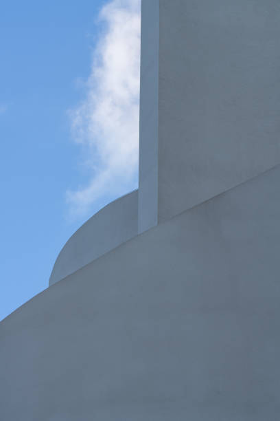 istock Minimalist concrete wall on blue sky background 2203033980