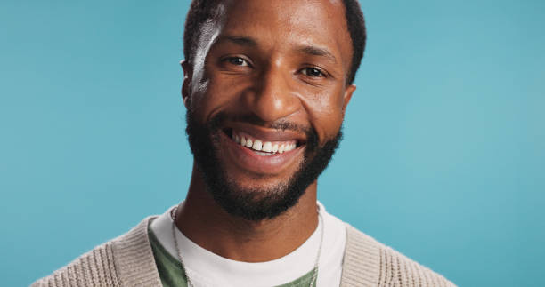 istock Portrait, graphic designer and black man in studio, smile and confident guy on blue background. African person, creative agency and illustrator with talent, consultant and business owner with pride 2203034209