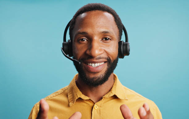 Black man, headset and call centre portrait in studio, hotline employee and blue background. Male person, telemarketing consultant and helping with customer care, professional service and advisor