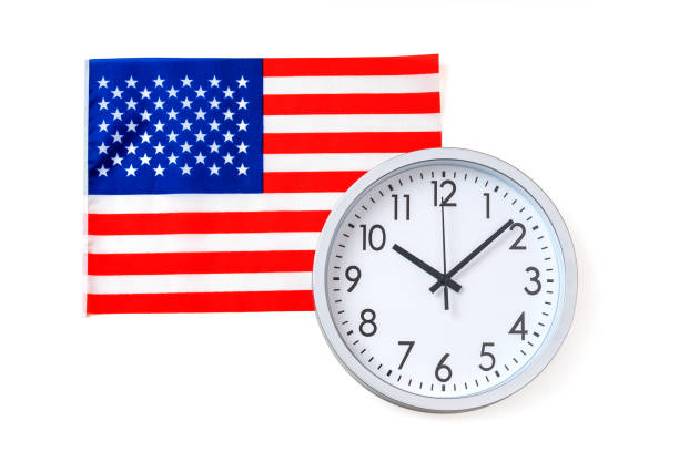 istock Round clock with dial on background of USA flag, isolated on white. 2203035063