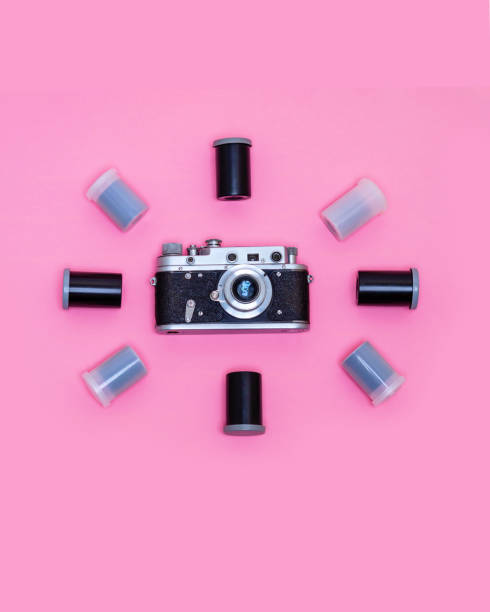 istock Retro camera surrounded by boxes with photo film. 2203036261
