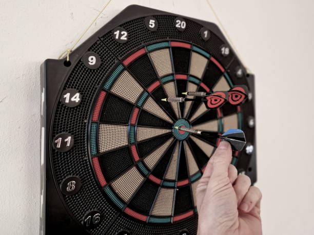 istock game include cricket,a game for two teams in which the players alternate between scoring inner bull's eyes and points; football, a game for two players 2203036559