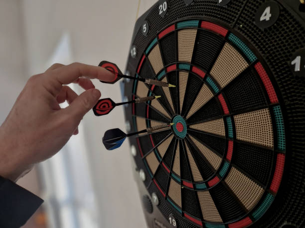 istock game include cricket,a game for two teams in which the players alternate between scoring inner bull's eyes and points; football, a game for two players 2203036675