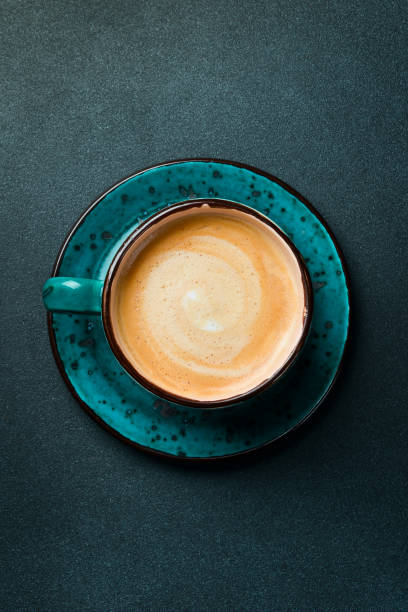 istock A cup of cappuccino and coffee beans. Top view, on a black background, free copy space. Robusta or Arabica. 2203038281