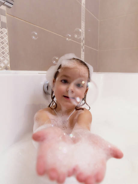 istock Girl playing with bubbles while bathing in bathtub 2203040403