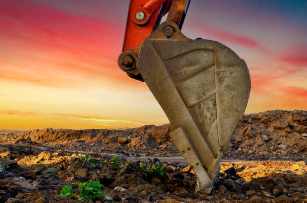 istock Excavator bucket Close-up at sunset. Earthworks, excavation. Open-pit mining. 2203041790