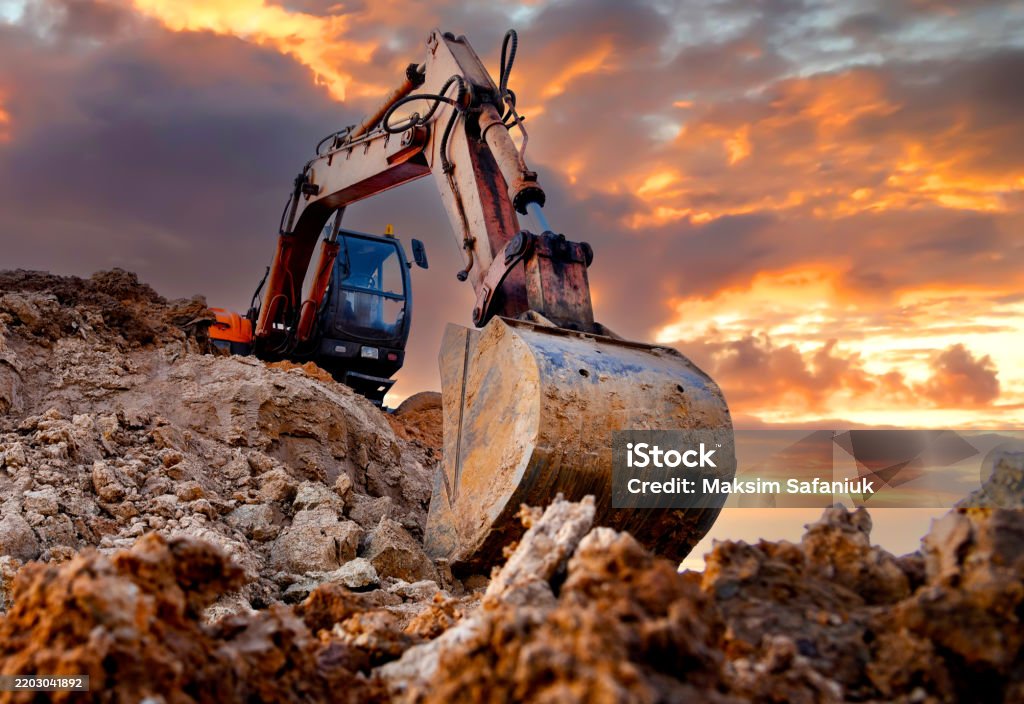 Backhoe Digging Sand Excavator During Earthmoving Work At Openpit Mining On Sunset ...