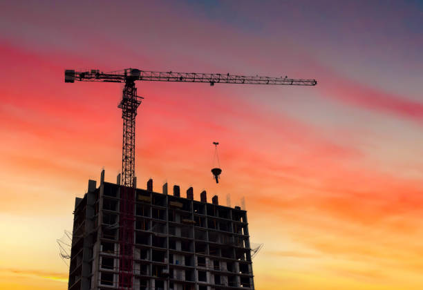 istock Building construction. Construction site on sunset. Tower crane on Housing, renovation. 2203041943
