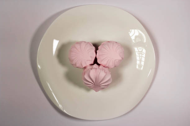 istock minimalistic photo of marshmallows in powdered sugar on a plate 2203044087
