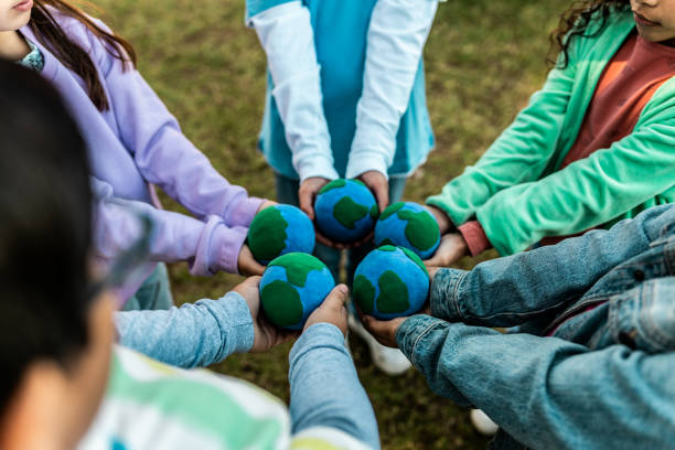 Kids holding globes outdoors