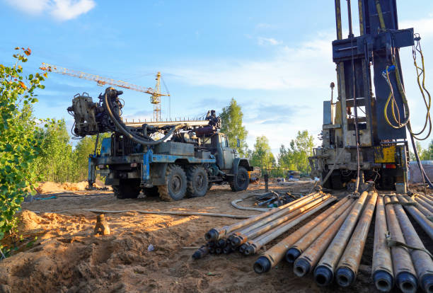 istock Deep foundation machine. Pile driver at construction site. Pile driven in ground by vibrating hydraulic hammer. 2203044375