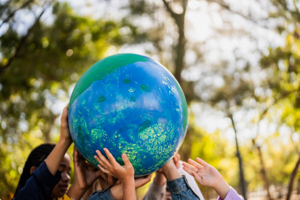 istock Kids holding a globe outdoors 2203044487