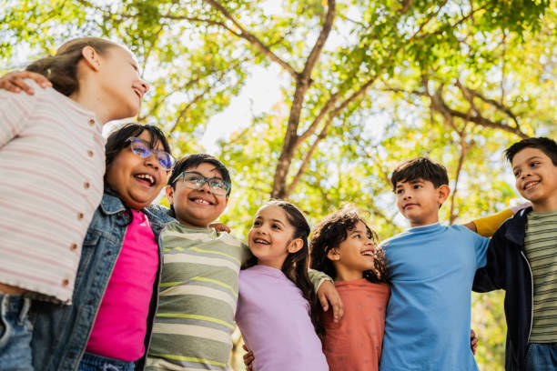 istock Child friends talking embraced on public park 2203044670