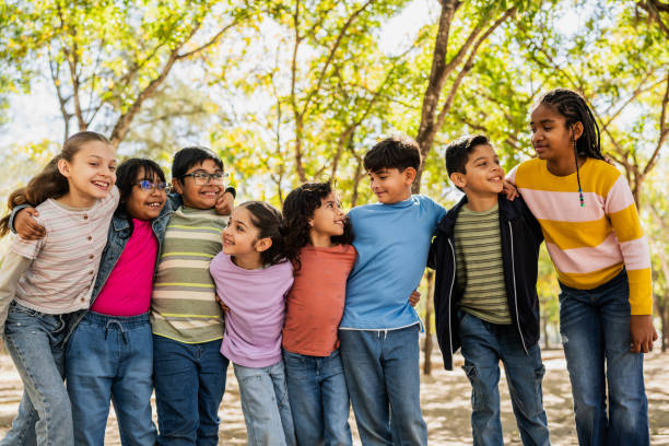 Child friends talking embraced on public park