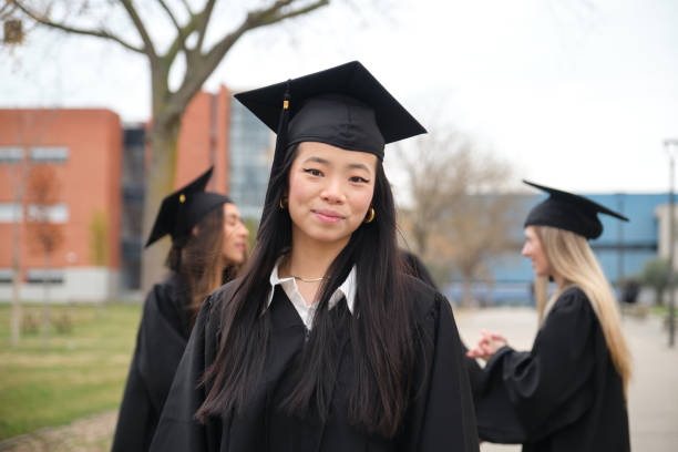 istock Young asian student smiling at graduation ceremony 2203047086