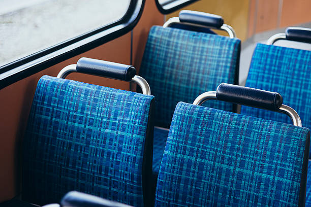 istock Blue passenger chairs in public bus. Vacant subway wagon with free seats. 2203047563