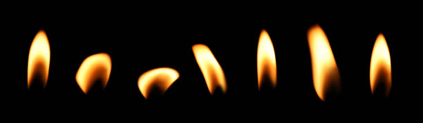 istock Flame of orange candle cut out on black background 2203048773