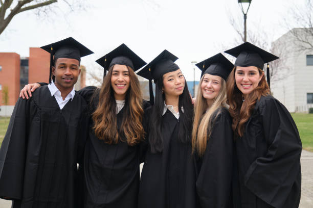 istock Happy multi-ethnic graduates smiling and posing together outside university 2203048779