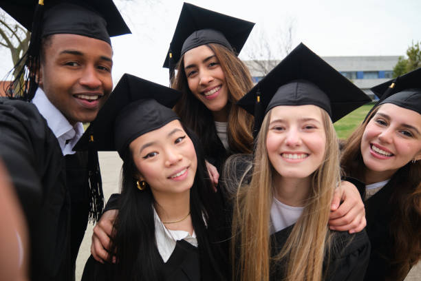 istock Happy multi-ethnic graduates taking a selfie celebrating graduation day 2203048919
