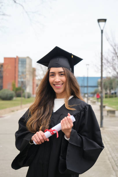 istock Young Graduate Smiling and Holding her Diploma in University Campus 2203049999