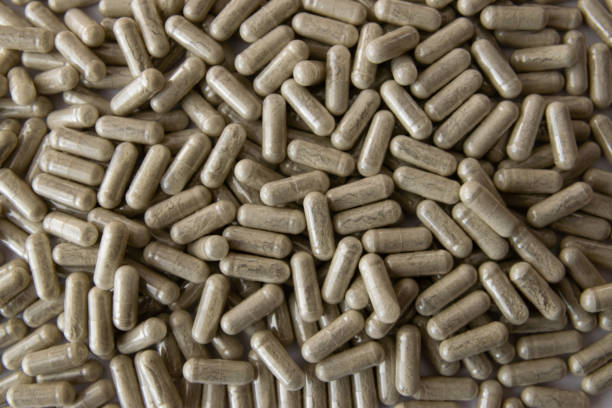 istock Green transparent tablets or pills on the white background. 2203050007