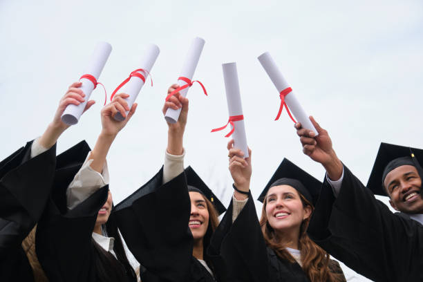 istock Happy students raising their diplomas at graduation ceremony 2203051534