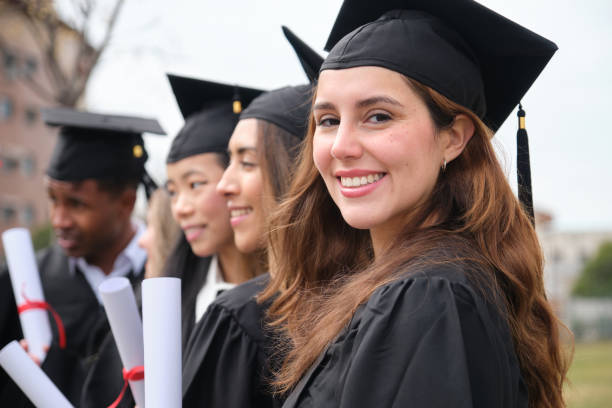istock Happy graduating students smiling and holding diplomas 2203052141