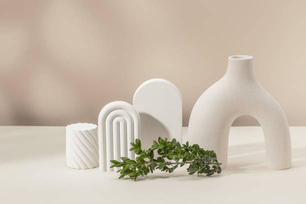 istock Stylish composition with a vase, plaster figures and a boxwood branch. Product presentation. Copy space. 2203053731