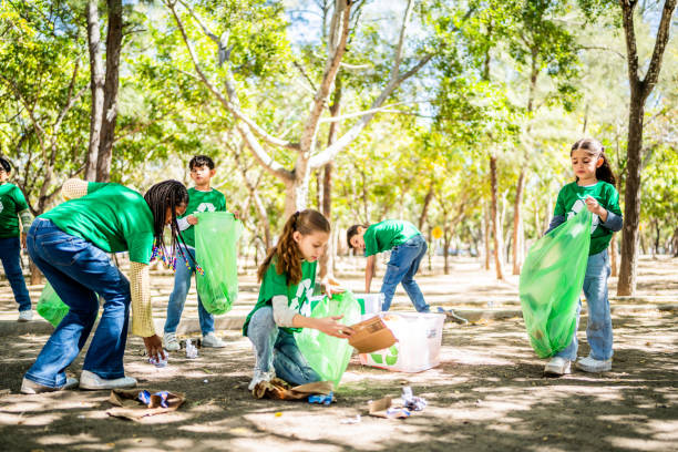 istock Child recyclers cleaning the public park 2203054076
