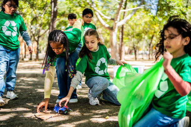 istock Child recyclers cleaning the public park 2203054094