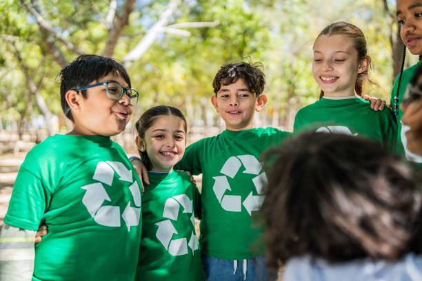 istock Child recyclers talking embraced on the public park 2203054710