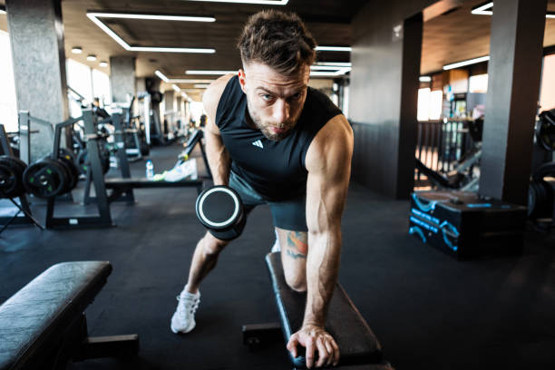 istock Motivated Man Strength Training with Dumbbells 2203054723