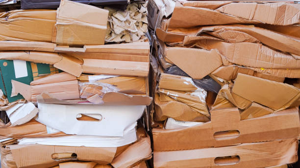 istock Stacked cardboard sorted outdoors for recycling, waste management concept 2203055140