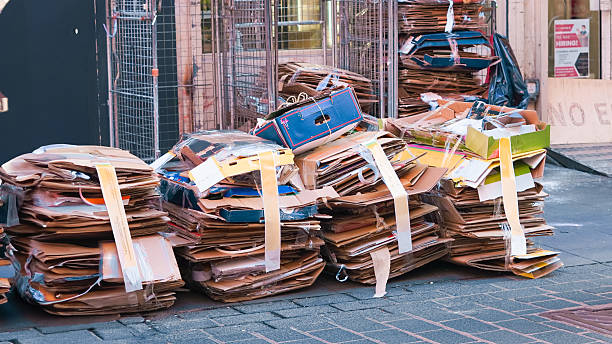 istock Stacked cardboard sorted outdoors for recycling, waste management concept 2203055168