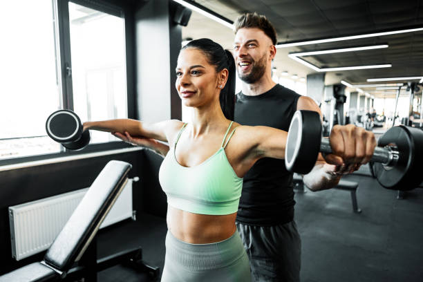 istock Working Out with Dumbbells With Fitness Instructor 2203055896