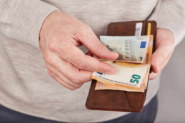 istock Man counting money. Leather wallet with euro money banknotes. 2203062425