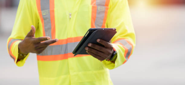 istock Hands, holding, tablet technology. Hands of worker working with digital tablet. Worker wearing uniform holding tablet at work. Checking, inspecting quality control 2203062867