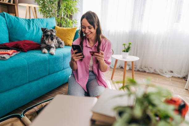 istock Young woman booking a trip online with her pet by her side 2203063441