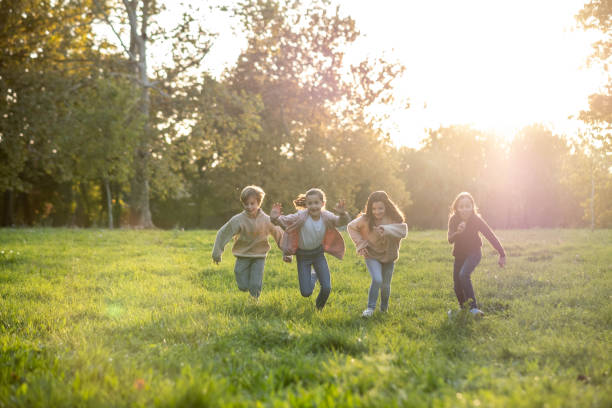 istock children are running in the meadow and playing 2203063700
