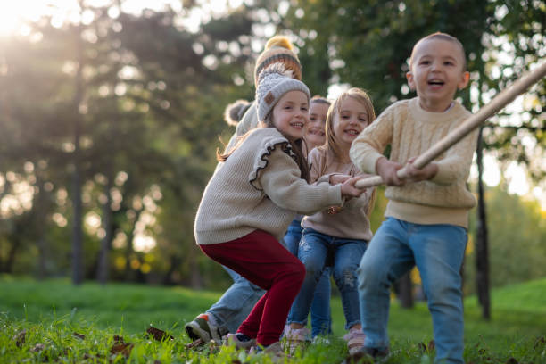istock children are playing in nature, pulling the rope 2203063763