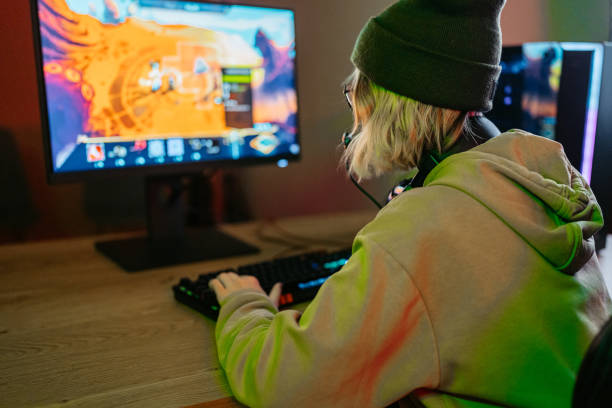 istock Young Woman Playing A Video Game On Her Desktop PC 2203064900