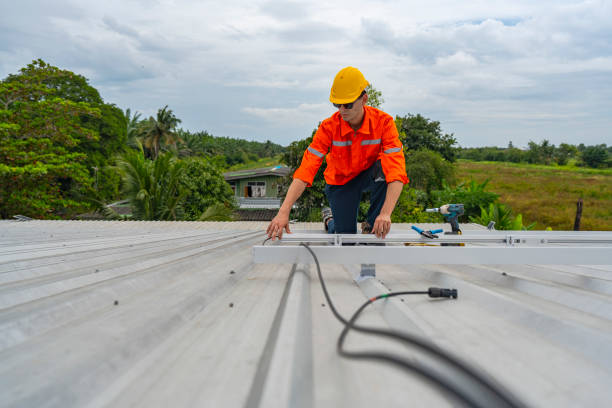istock Technician in safety uniform and helmet kneeling on a rooftop, using a drill for precise installation work. A scene highlighting safety, professionalism, and technical expertise in construction. 2203066181