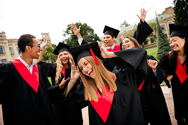 istock Joyful college graduates celebrating together outdoors on a vibrant summer day, expressing happiness and accomplishment. 2203067495