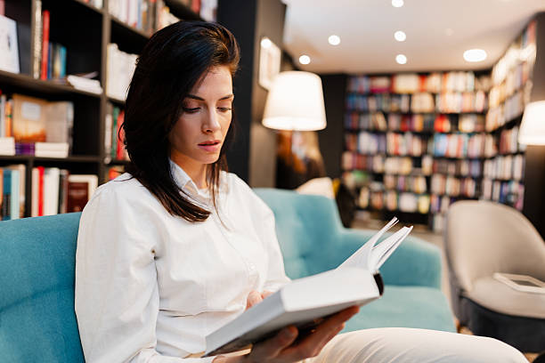 istock Beautiful female student reading a book 2203067574
