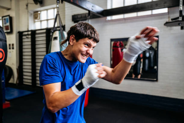 istock Dedicated young fighter shadow boxing at youth club 2203067944